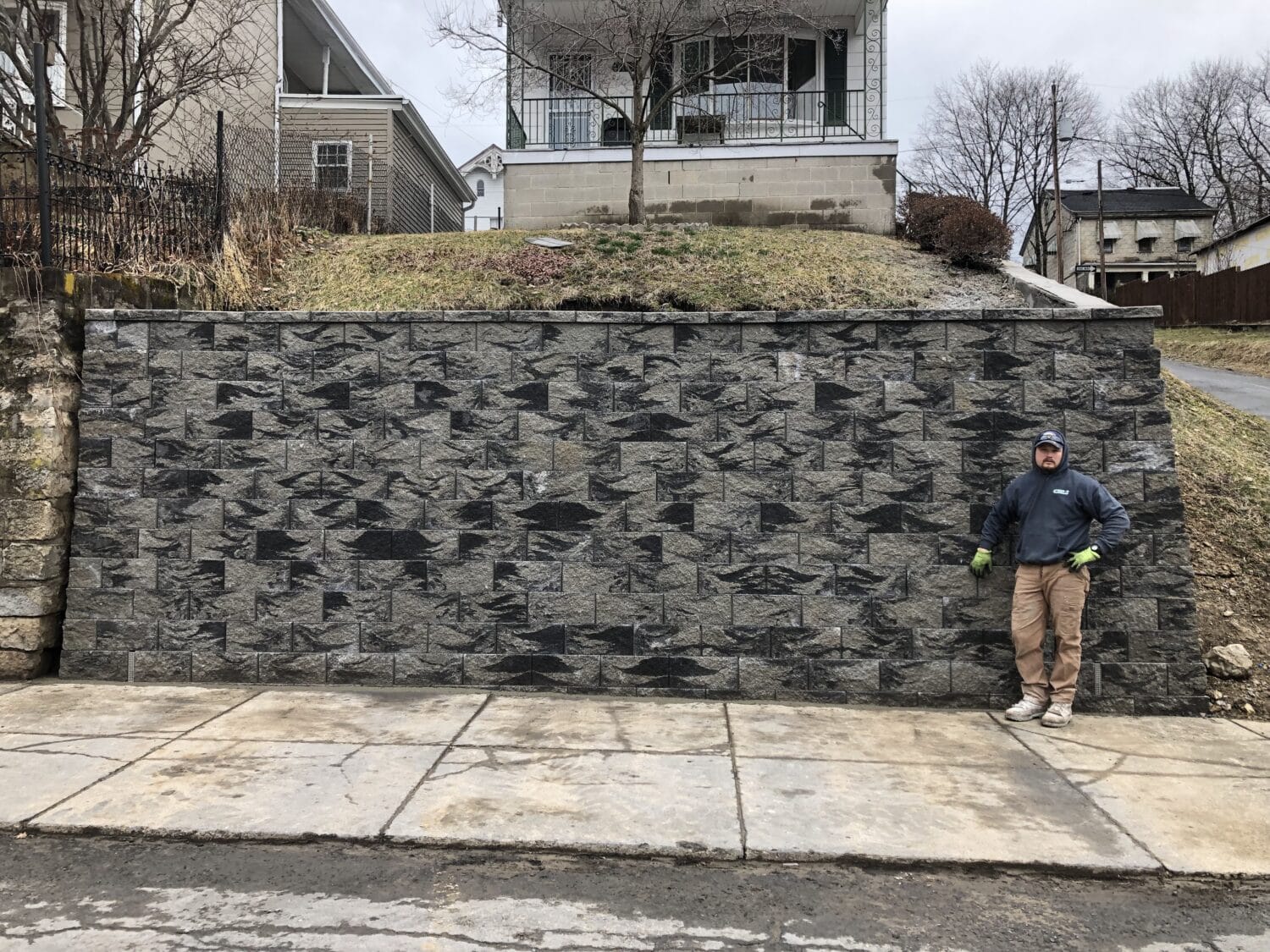 New large retaining wall in front of house on hill