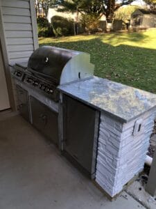 A bbq grill on a patio.
