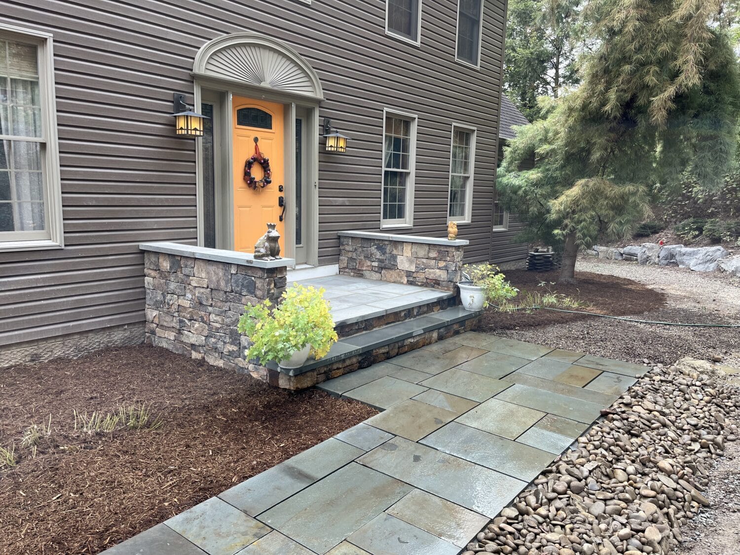 Stone walkway and staircase leading to front door of home